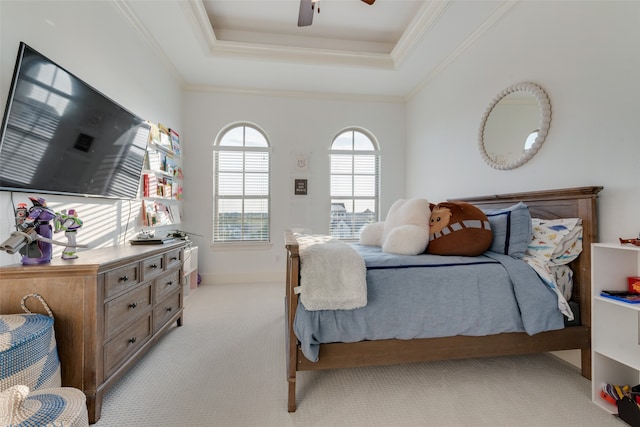 bedroom featuring ceiling fan, a raised ceiling, light carpet, and crown molding