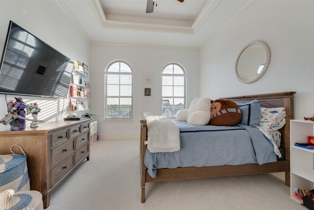 bedroom with crown molding, a ceiling fan, light colored carpet, and a raised ceiling