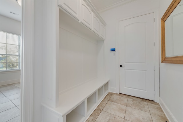 mudroom featuring ornamental molding and light tile patterned floors