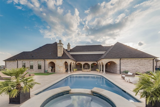 view of swimming pool with an in ground hot tub and a patio area