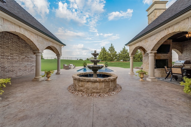 view of patio / terrace with an outdoor stone fireplace