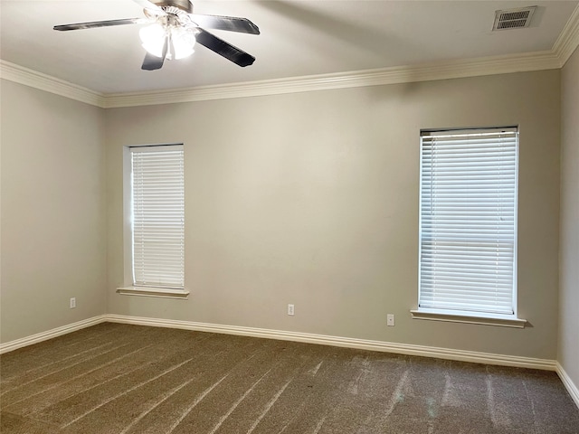 carpeted empty room featuring ornamental molding, ceiling fan, and plenty of natural light