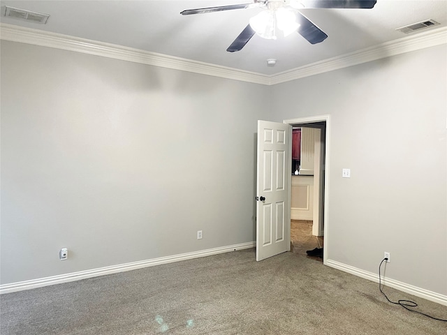 carpeted empty room featuring ornamental molding and ceiling fan