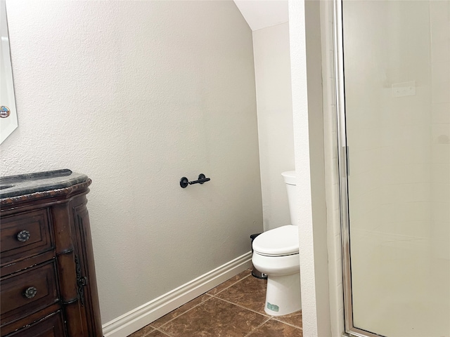 bathroom with walk in shower, tile patterned floors, toilet, and vanity