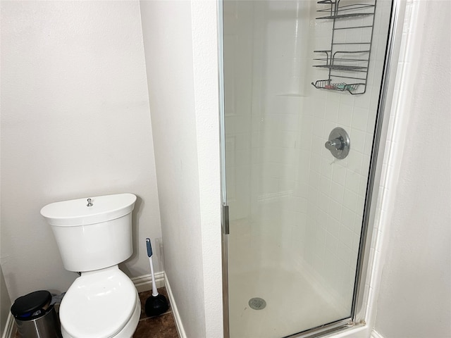 bathroom with walk in shower and toilet