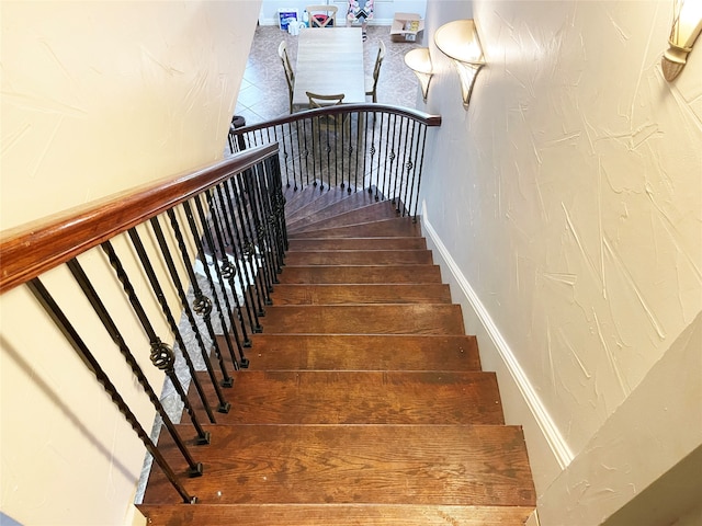 staircase with hardwood / wood-style flooring