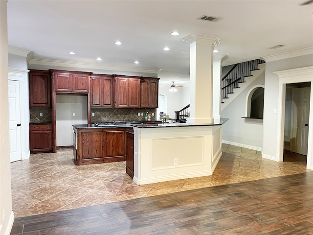 kitchen with decorative columns, light tile patterned floors, kitchen peninsula, backsplash, and ceiling fan