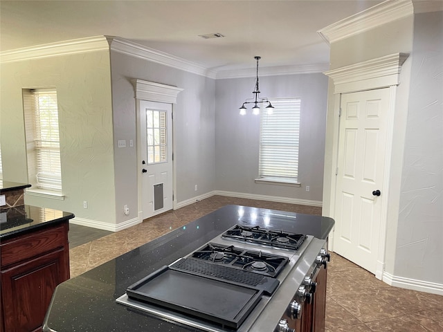 kitchen featuring cooktop, tile patterned floors, a chandelier, hanging light fixtures, and ornamental molding