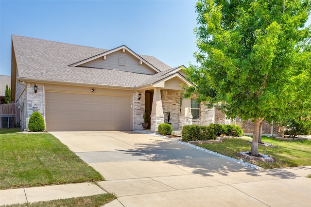 view of front of property with a garage, cooling unit, and a front yard