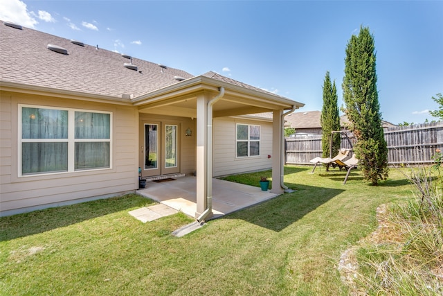 rear view of property with a patio and a yard