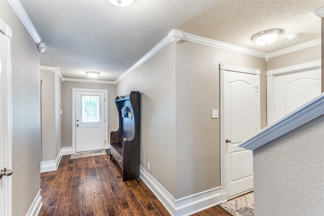 interior space featuring dark wood-type flooring, a textured ceiling, and crown molding