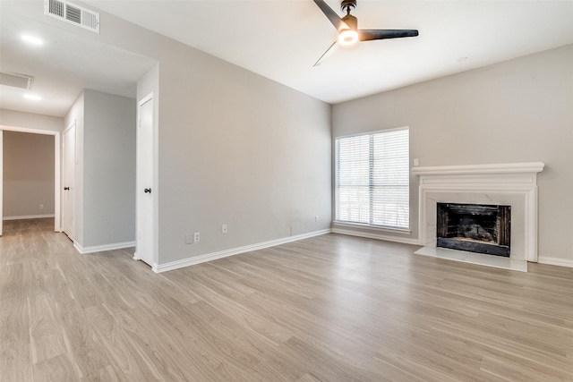 unfurnished living room with light hardwood / wood-style flooring and ceiling fan