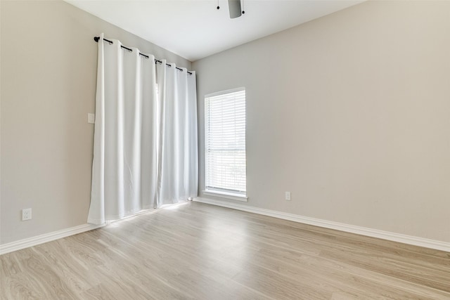 empty room with ceiling fan and light wood-type flooring