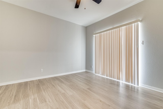 spare room with light hardwood / wood-style flooring and ceiling fan