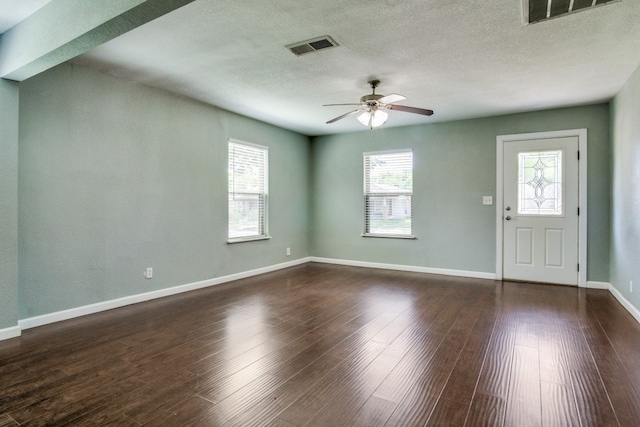 entryway featuring hardwood / wood-style floors, a textured ceiling, ceiling fan, and a wealth of natural light