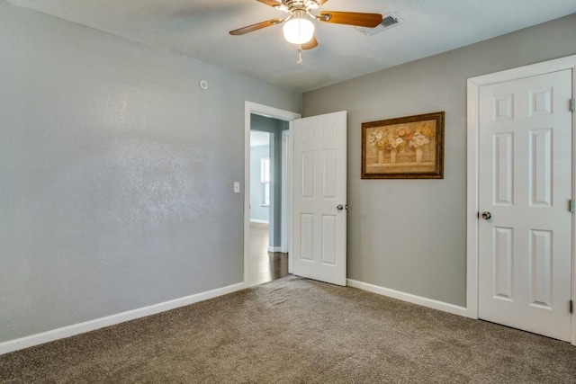 unfurnished bedroom featuring ceiling fan and carpet flooring