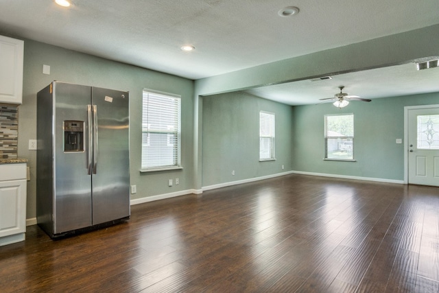 interior space featuring dark wood-type flooring, a textured ceiling, and ceiling fan