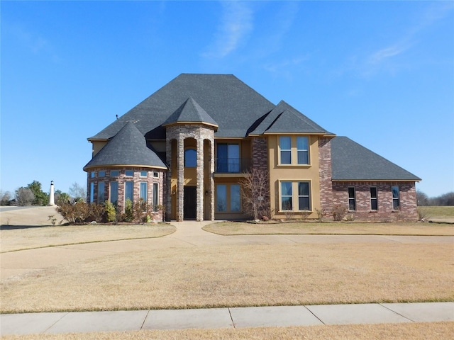 view of front facade with brick siding and roof with shingles