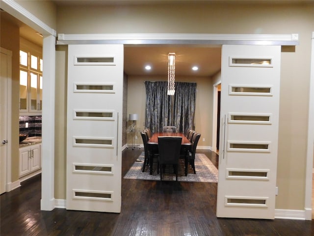 dining area with baseboards and dark wood-type flooring