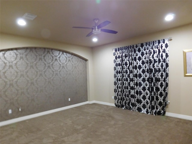 carpeted empty room featuring a ceiling fan, visible vents, baseboards, and recessed lighting