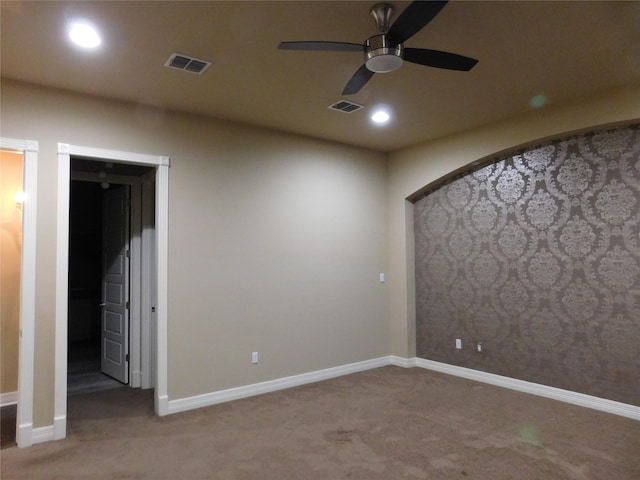 carpeted empty room featuring baseboards, visible vents, recessed lighting, and a ceiling fan