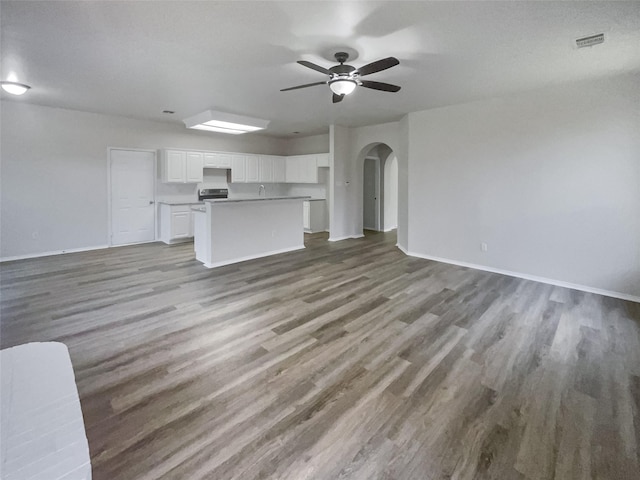 unfurnished living room featuring ceiling fan and light hardwood / wood-style floors