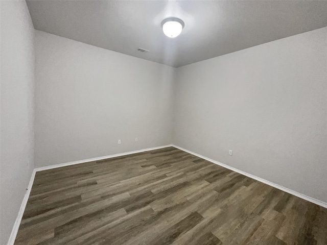 spare room featuring dark hardwood / wood-style floors