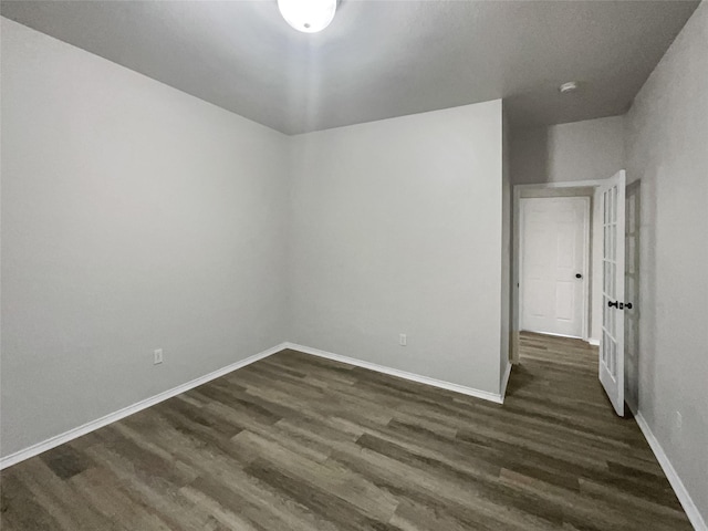 spare room with dark hardwood / wood-style floors