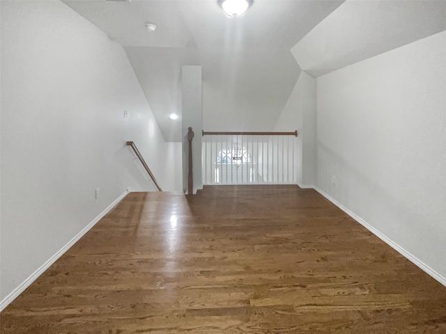 additional living space with lofted ceiling and dark wood-type flooring