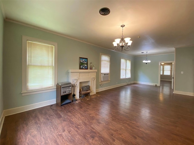 unfurnished living room featuring a chandelier, visible vents, ornamental molding, and wood finished floors