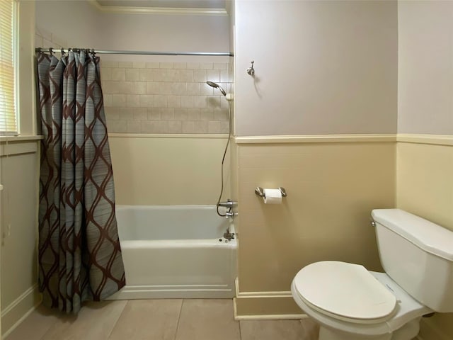 bathroom with shower / bathtub combination with curtain, toilet, and tile patterned floors