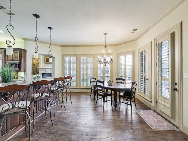 dining space with an inviting chandelier, dark wood-type flooring, plenty of natural light, and crown molding