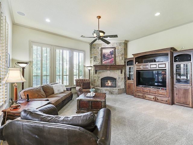 living room with crown molding, light colored carpet, a fireplace, and ceiling fan