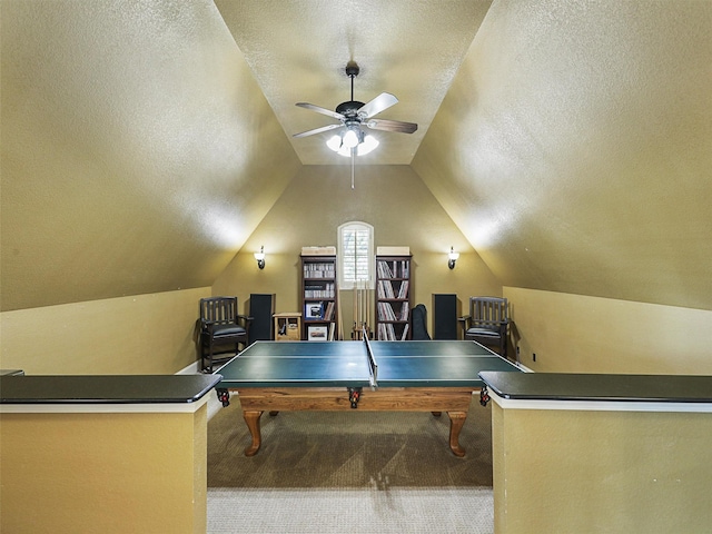 playroom featuring ceiling fan, carpet floors, a textured ceiling, and vaulted ceiling