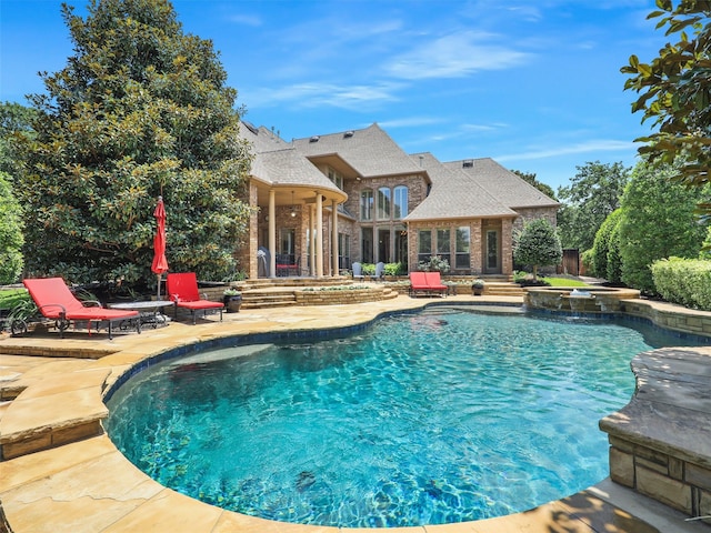 view of pool featuring a patio area and an in ground hot tub