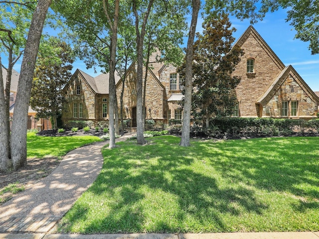 tudor home with a front yard