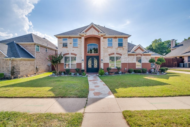 view of front of house featuring stone siding, a front lawn, and french doors