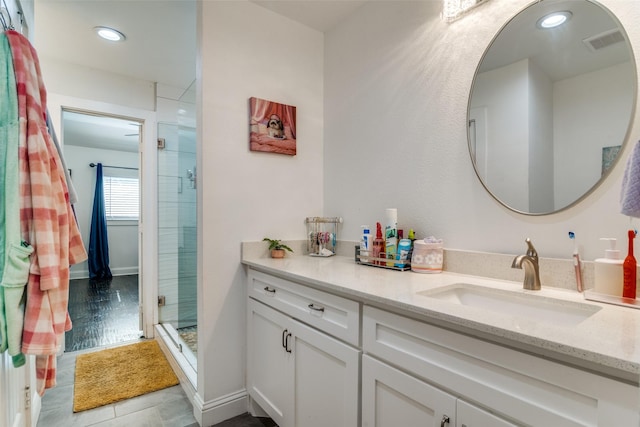 full bath with a stall shower, recessed lighting, visible vents, and vanity