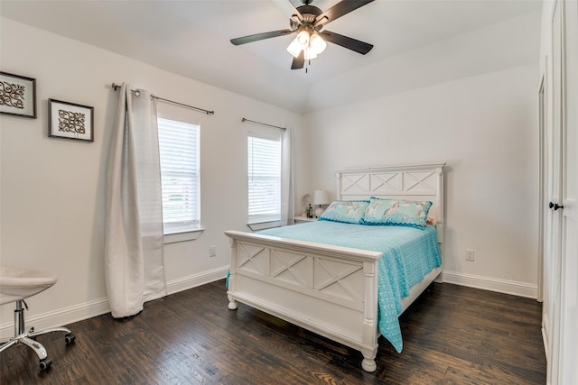 bedroom with lofted ceiling, ceiling fan, baseboards, and wood finished floors