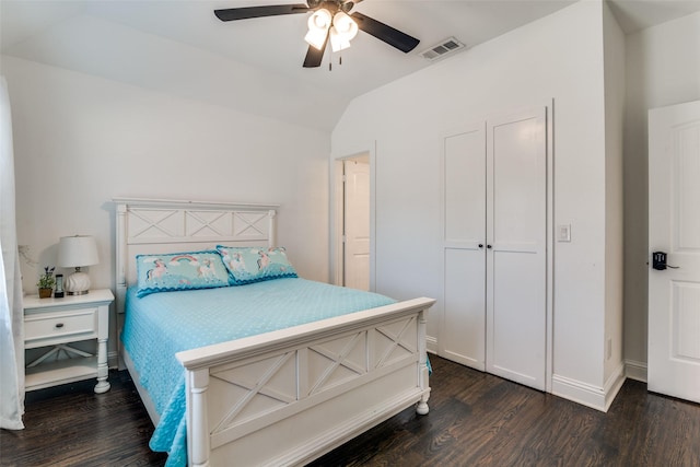 bedroom with vaulted ceiling, dark wood-type flooring, visible vents, and a ceiling fan