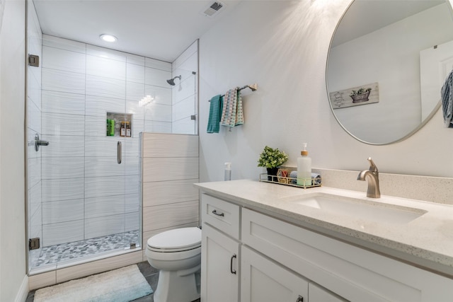 full bath featuring toilet, a shower stall, visible vents, and vanity