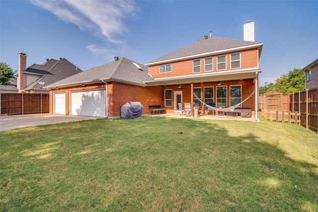 view of front of property with a patio, an attached garage, a fenced backyard, brick siding, and a ceiling fan