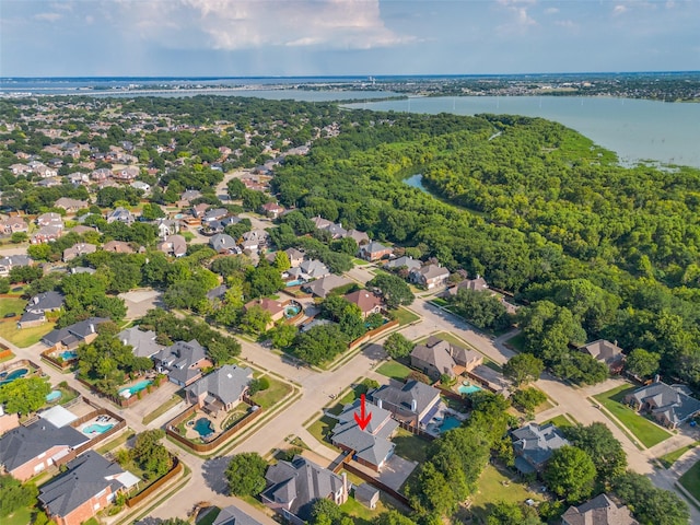 aerial view with a forest view, a water view, and a residential view