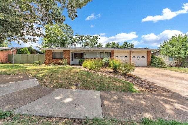 ranch-style home with a garage and a front lawn