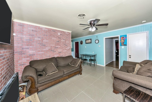 tiled living room featuring ceiling fan, brick wall, and ornamental molding