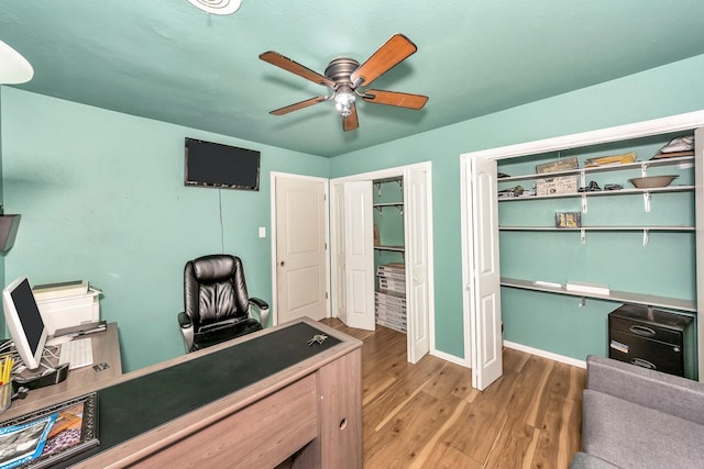 office space with hardwood / wood-style floors and ceiling fan