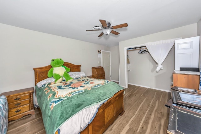 bedroom featuring wood-type flooring, ceiling fan, and a closet