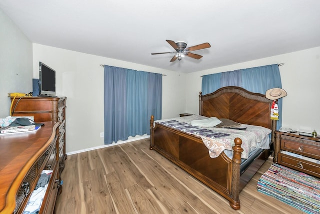 bedroom with hardwood / wood-style flooring and ceiling fan