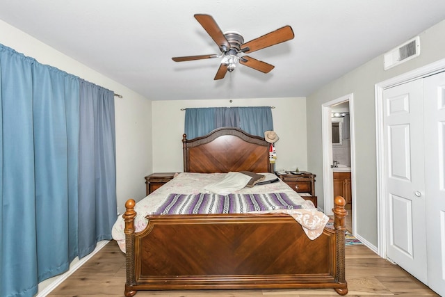 bedroom featuring ceiling fan, connected bathroom, and hardwood / wood-style floors