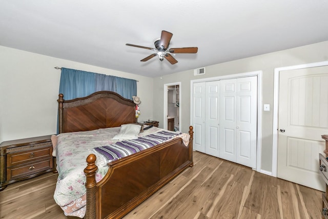 bedroom with light hardwood / wood-style flooring, a closet, and ceiling fan